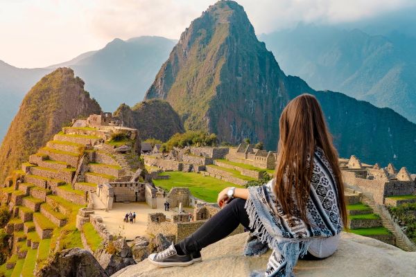 Girl sitting in front of Machu Picchu Peru, South America