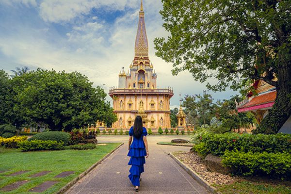 lady walking towards temple in phuket