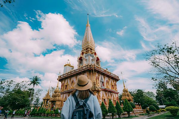 lady standing in front of temple in phuket