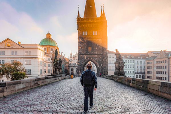 man walking toward building in prague