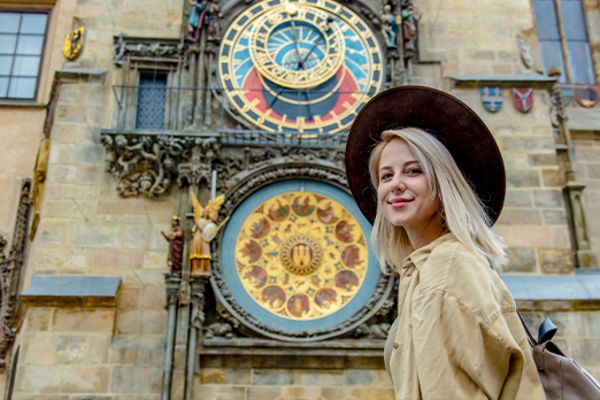 lady walking past building in prague