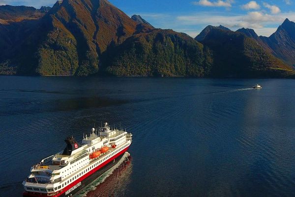 Cruise ship travelling through to mountain ranges