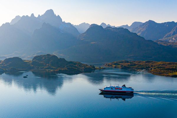 Cruise ship travelling through mountain ranges