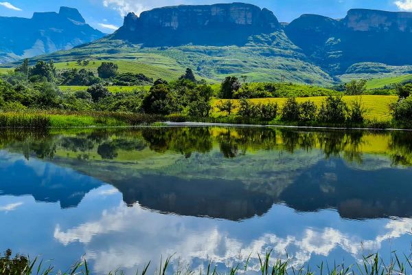 Mirror lake surrouned by grass ranges