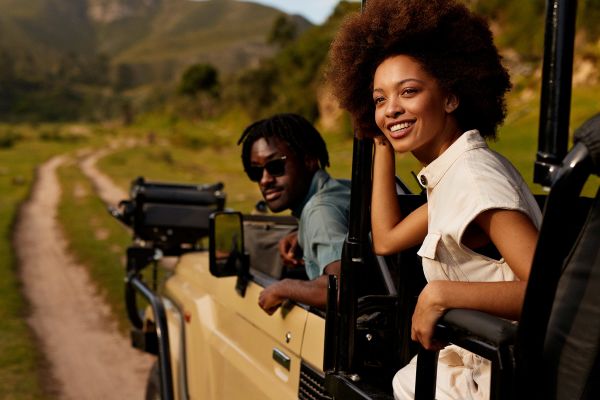 People hanging out of a jeep on safari