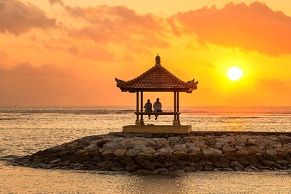 two people in a hut on the beach