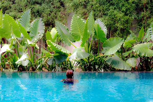 lady in pool with plants in background
