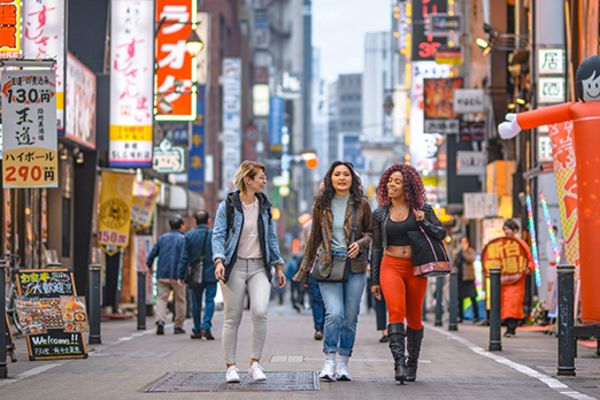 group of three women walking down road in shinjuku