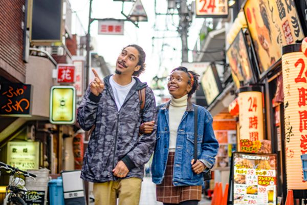 couple walking down road in shinjuku