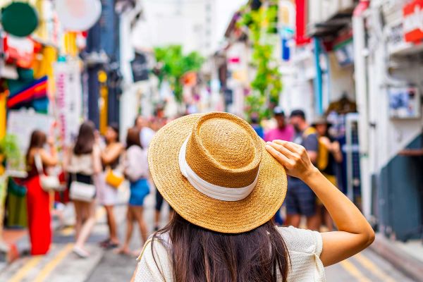 Woman with her arms spread looking out at Singapore Bay