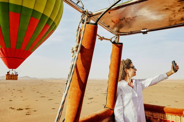 Woman taking a selfie in a hot air balloon