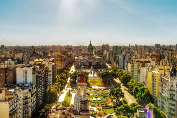 Three friends walking down a street in a tropical city
