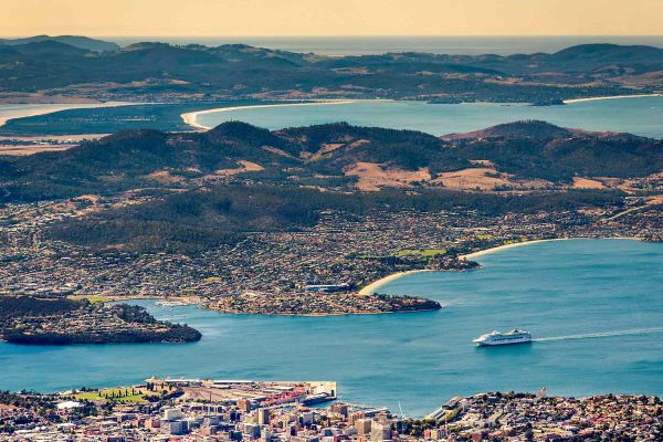 Drone shot of a cruise ship and mountain ranges