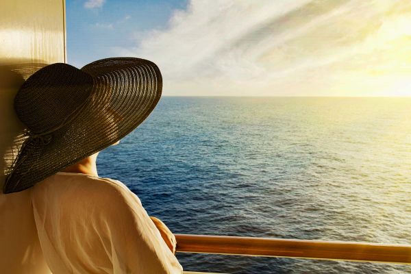 Lady looking out at sea from balcony