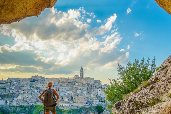 Standing on rock formations overlooking city