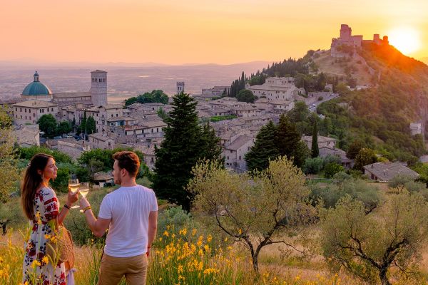 Couple toasting champagne in front of sunset