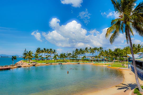 Man made beach surrounded by palm trees