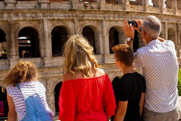 Family of 4 taking photos of the Colosseum