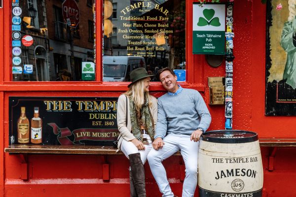 Couple sitting on a bench outside an Irish pub