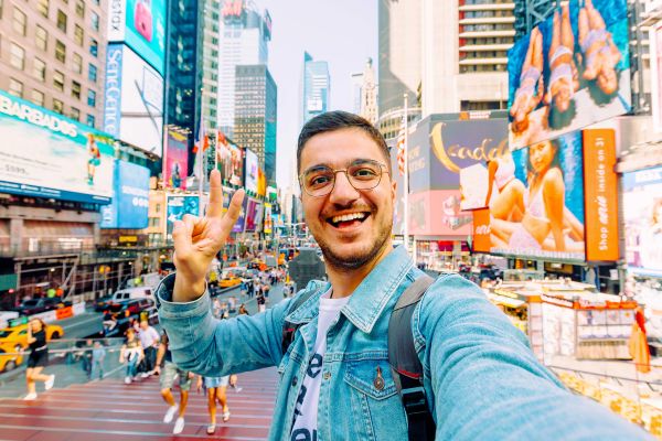 Man taking a selfie in Times Square in New York City