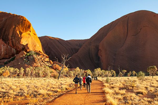 People walking towards Uluru