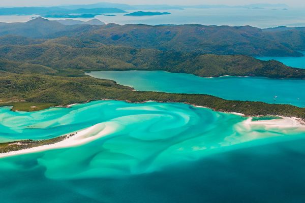 Drone shot of clean white sand with turquoise water
