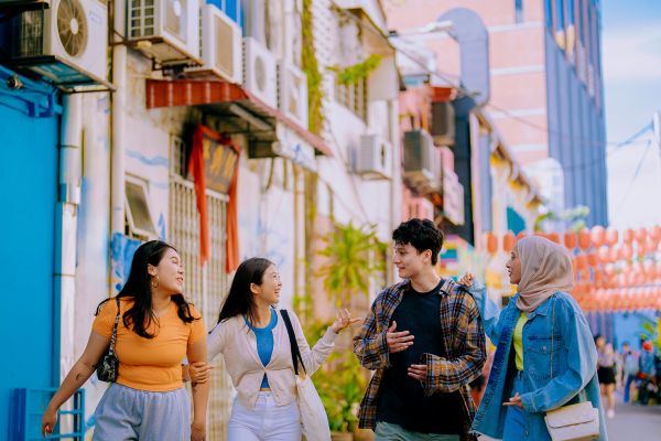 People walking down a street lined with wall-mounted air conditioners