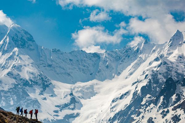 Standing on hill in front of snowy mountains