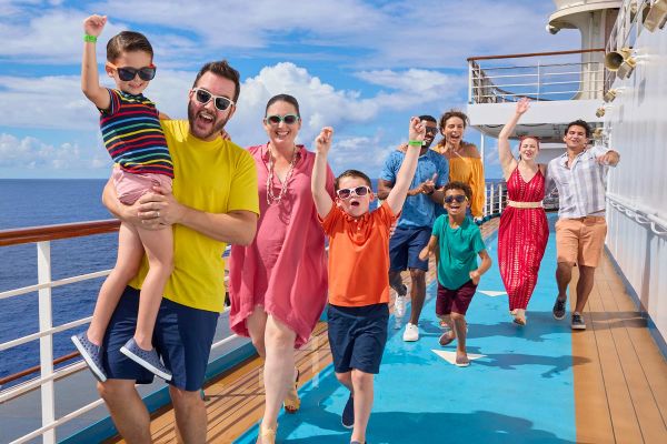 Family smiling walking down the deck