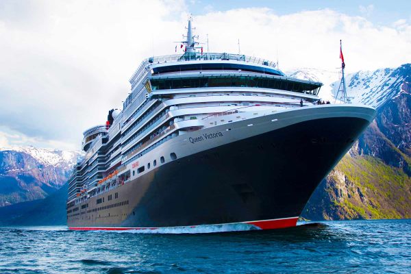 Cruise ship with cloudy blue sky above