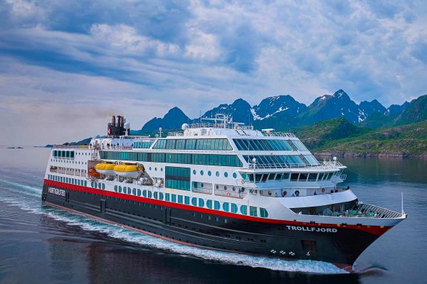 Cruise ship with mountain range in distance