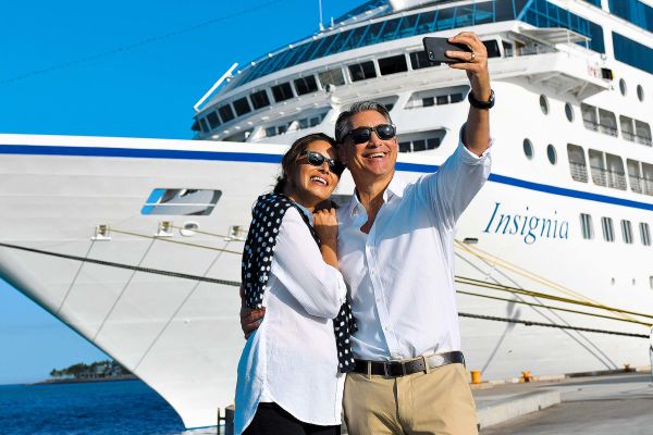 Couple posing in front of docked ship