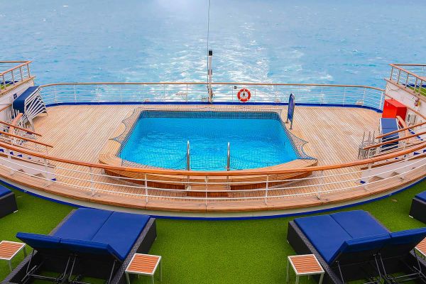 Image of pool on the back deck with two lounge chairs