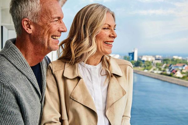 Mature couple looking over balcony railing