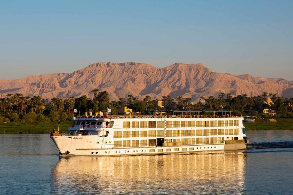 Uniworld River Cruise ship with mountains in the background