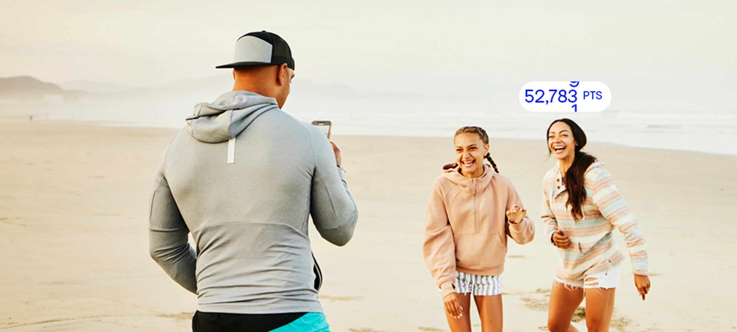 A family walking along a coastal boardwalk trail overlooking the ocean