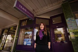 Travel Associates advisor at an office entrance