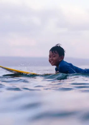 Father and son surfing in Bali