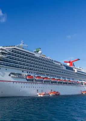 Cruise ship Carnival Splendor moored off a tropical island
