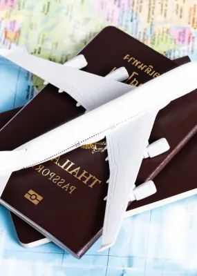 plane sitting on passports on top of map