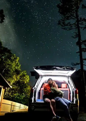 A couple gazing up at a starry night sky