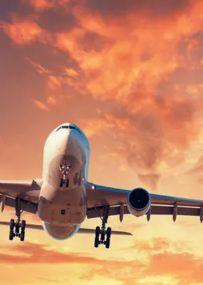 An airliner lands at sunset