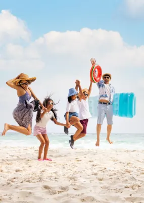 Family jumping happily on a beach