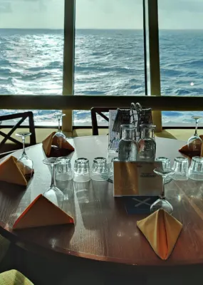 A cruise ship's dining table overlooking the sea