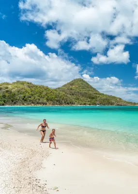 mother and son running on beach