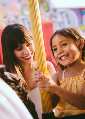 Mother and daughter on carousel ride