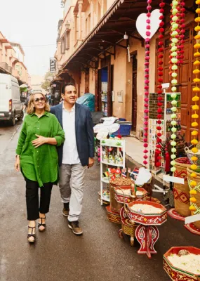 tourists walking past shops on local town street