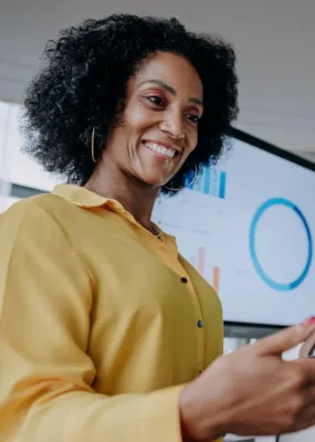 lady in yellow shirt holding phone 