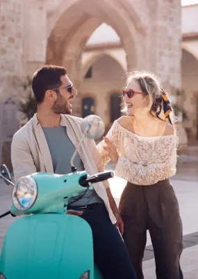 couple standing by scooter in town in europe