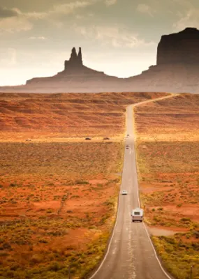 Cars driving along the road of Oljato-Monument Valley